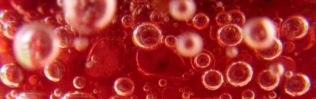 Fizzy bubbles on a red background.